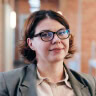 A woman with short hair wearing eyeglasses.